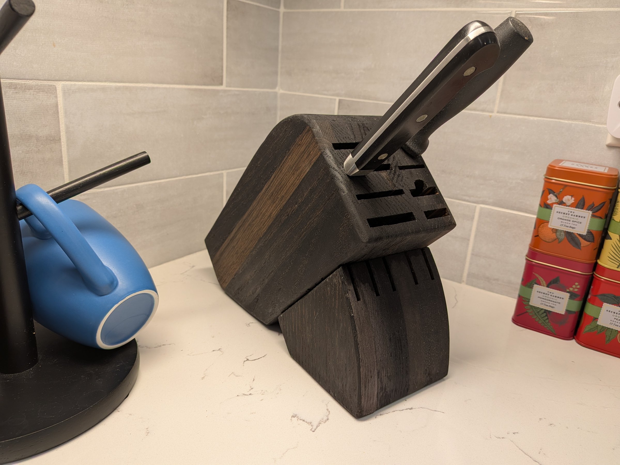 two-tone wood knife block on a kitchen counter built from reclaimed church pews